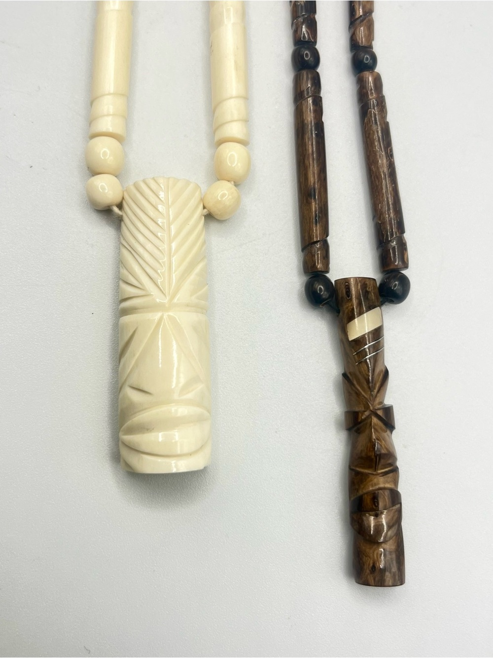 Two Hand-Carved Tiki Pendant Necklaces - Bovine and Wood unisex